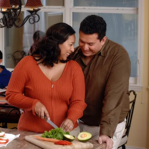 wife preparing a salad for her husband